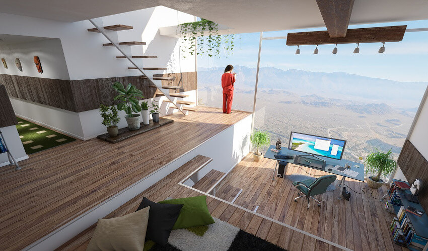 Ein Arbeitszimmer einer Villa mit einer Glasfassade und Blick Richtung unbebauter Natur und Berge.